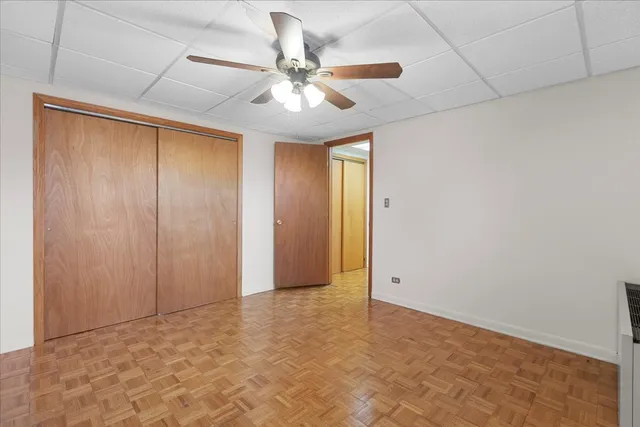 a view of a room with a ceiling fan and a rug