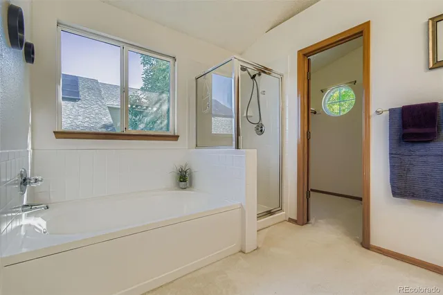 a bathroom with a tub and a shower
