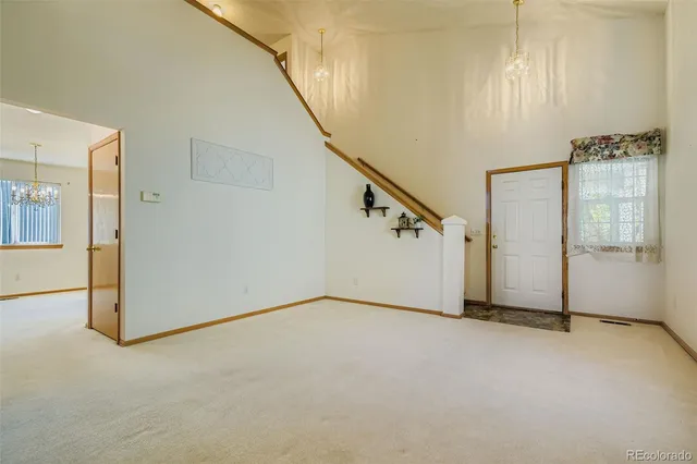 a view of an empty room with stairs
