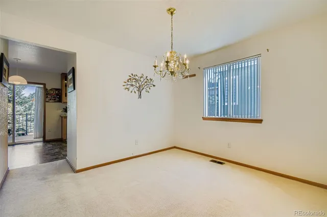 an empty room with windows and entrance