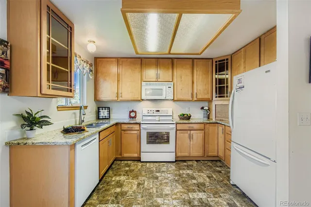 a kitchen with a sink cabinets stainless steel appliances and a window