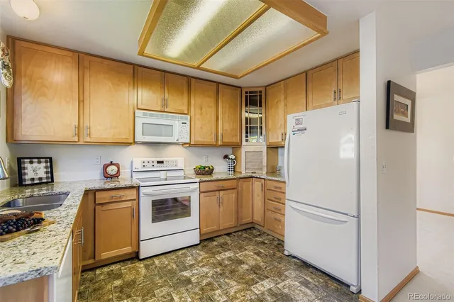 a kitchen with a refrigerator stove and sink