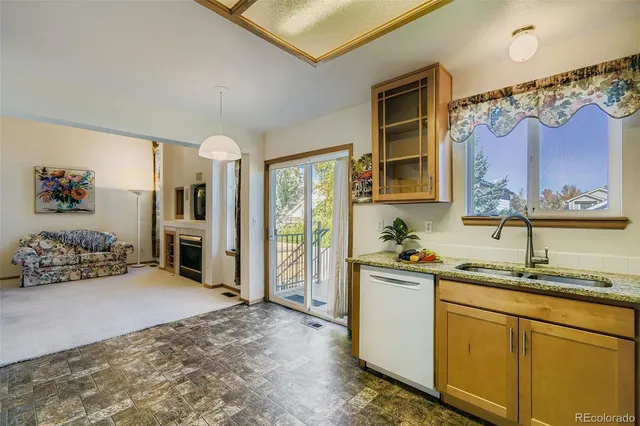 a kitchen that has a lot of cabinets and wooden floor