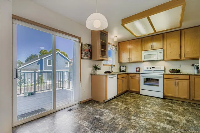 a kitchen with a stove a sink and a refrigerator