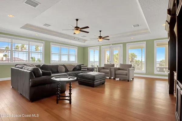 a view of a dining room with furniture a chandelier and kitchen view