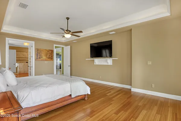 a bedroom with a bed a dresser and a window