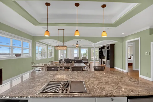 a spacious bathroom with a granite countertop sink a mirror and shower