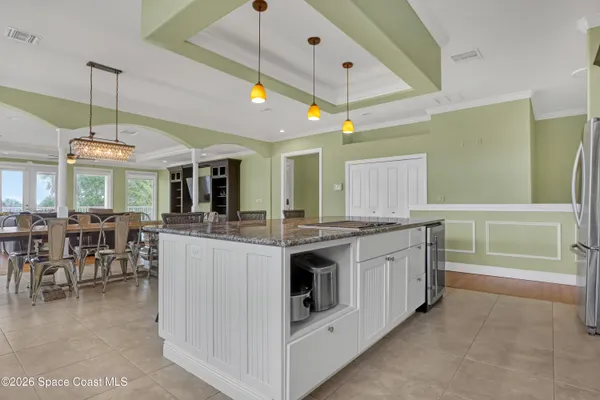 a bedroom with two beds and a chandelier