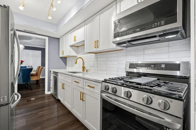 a view of a dining room with furniture a chandelier and wooden floor