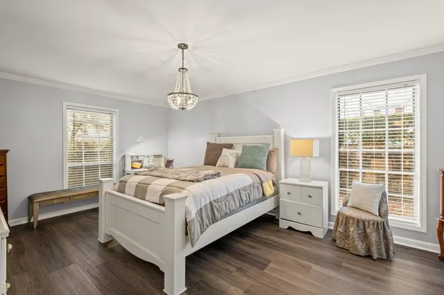 a bedroom with a bed and a chandelier