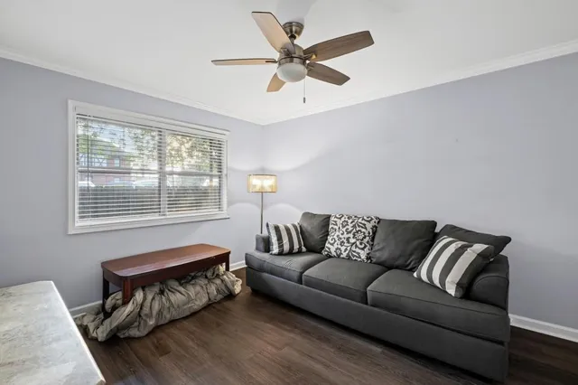 a living room with furniture and a ceiling fan