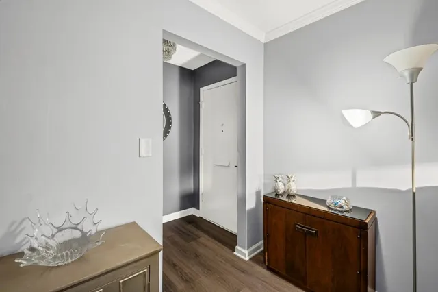 a bedroom with a bed a couch and a flat tv screen on the dresser
