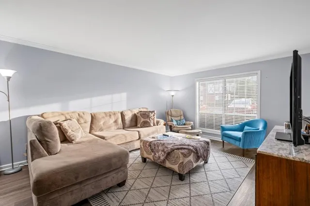 a bedroom with furniture and a flat screen tv