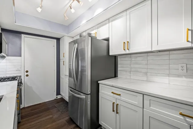 a kitchen with a refrigerator and a sink