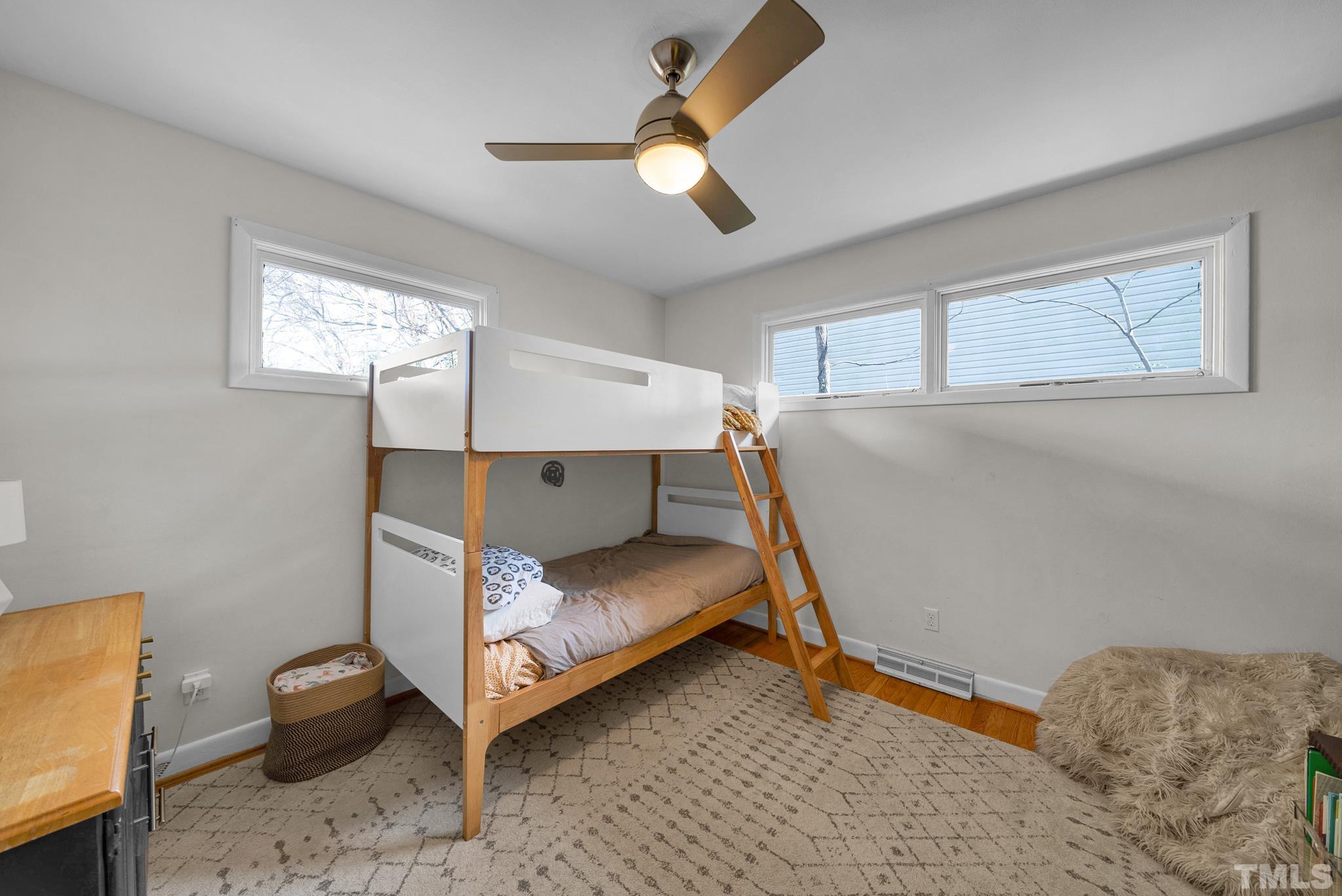 903 Bragg Street Raleigh, NC 27610 - Photo 32 of 37 a bedroom with a bed and a chandelier fan