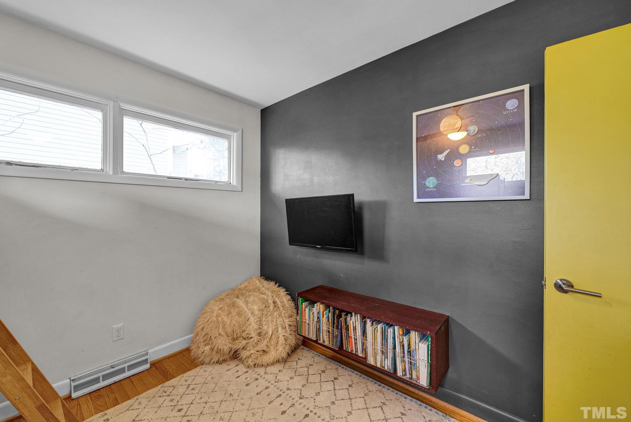 903 Bragg Street Raleigh, NC 27610 - Photo 33 of 37 a bedroom with a bed and a flat screen tv