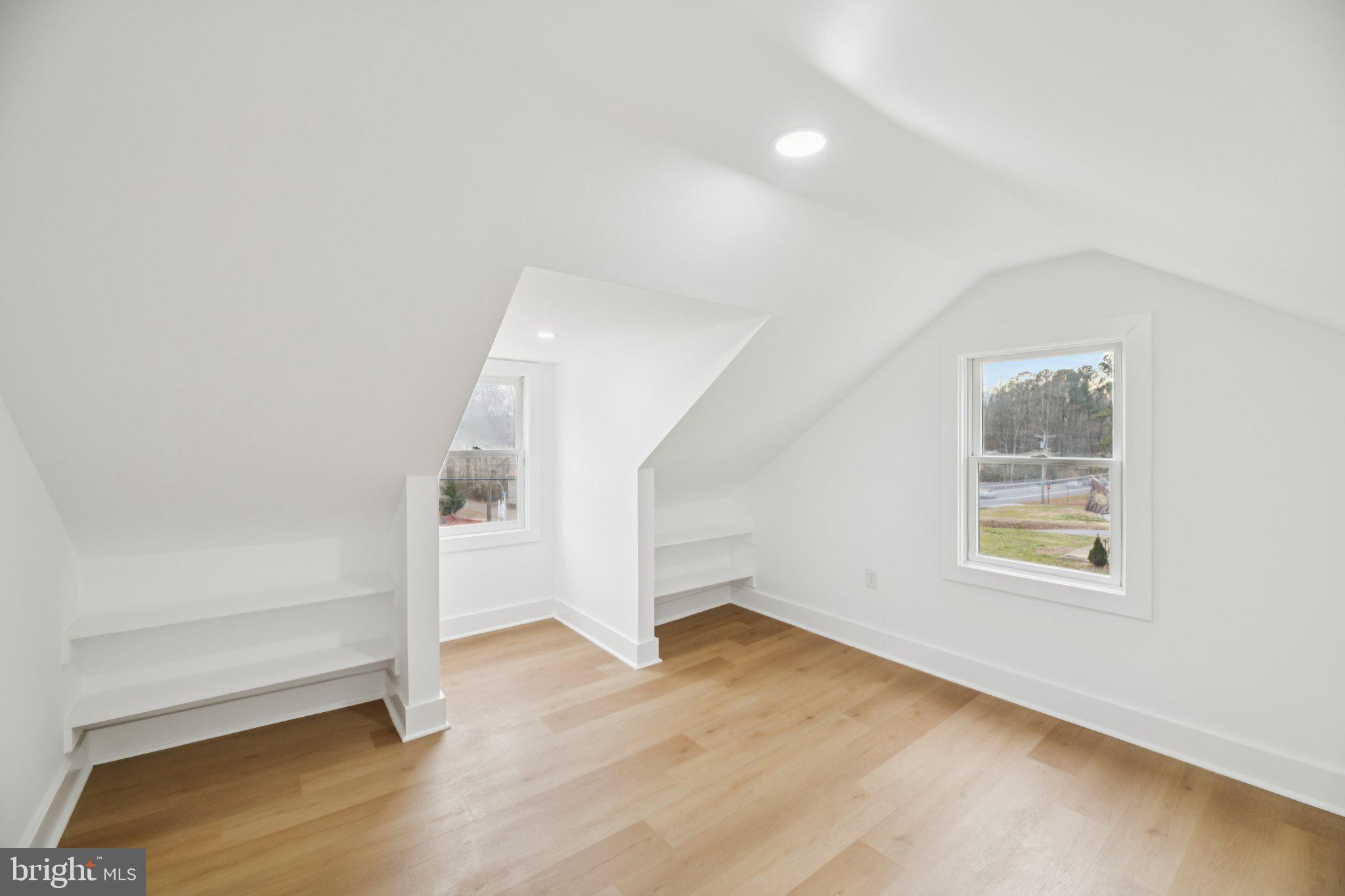 24399 Morgan Road Hollywood, MD 20636 - Photo 16 of 40 an empty room with wooden floor and windows