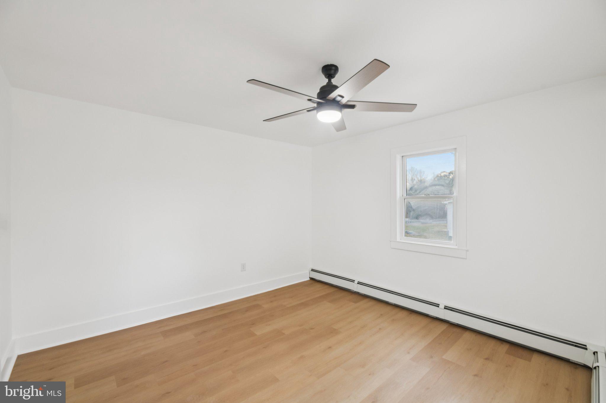 24399 Morgan Road Hollywood, MD 20636 - Photo 19 of 40 an empty room with a window and a ceiling fan