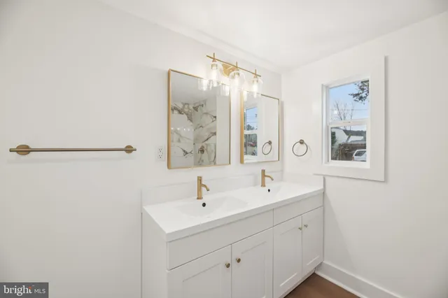 a bathroom with a double vanity sink and mirror