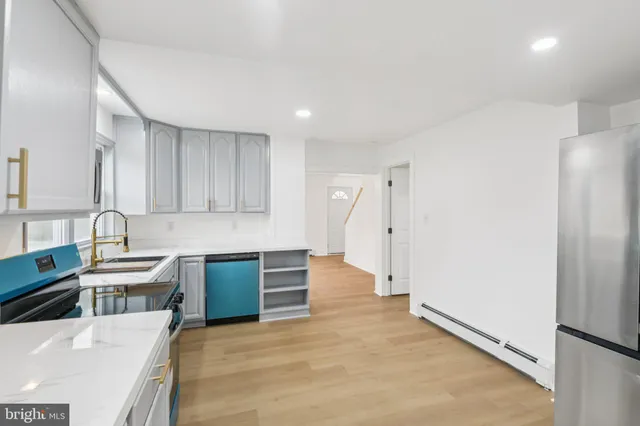 a kitchen with granite countertop a refrigerator and a sink