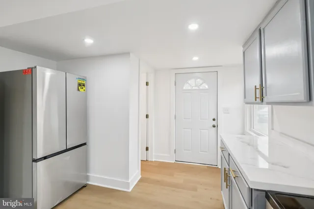 a view of a kitchen with a refrigerator cabinets and wooden floor