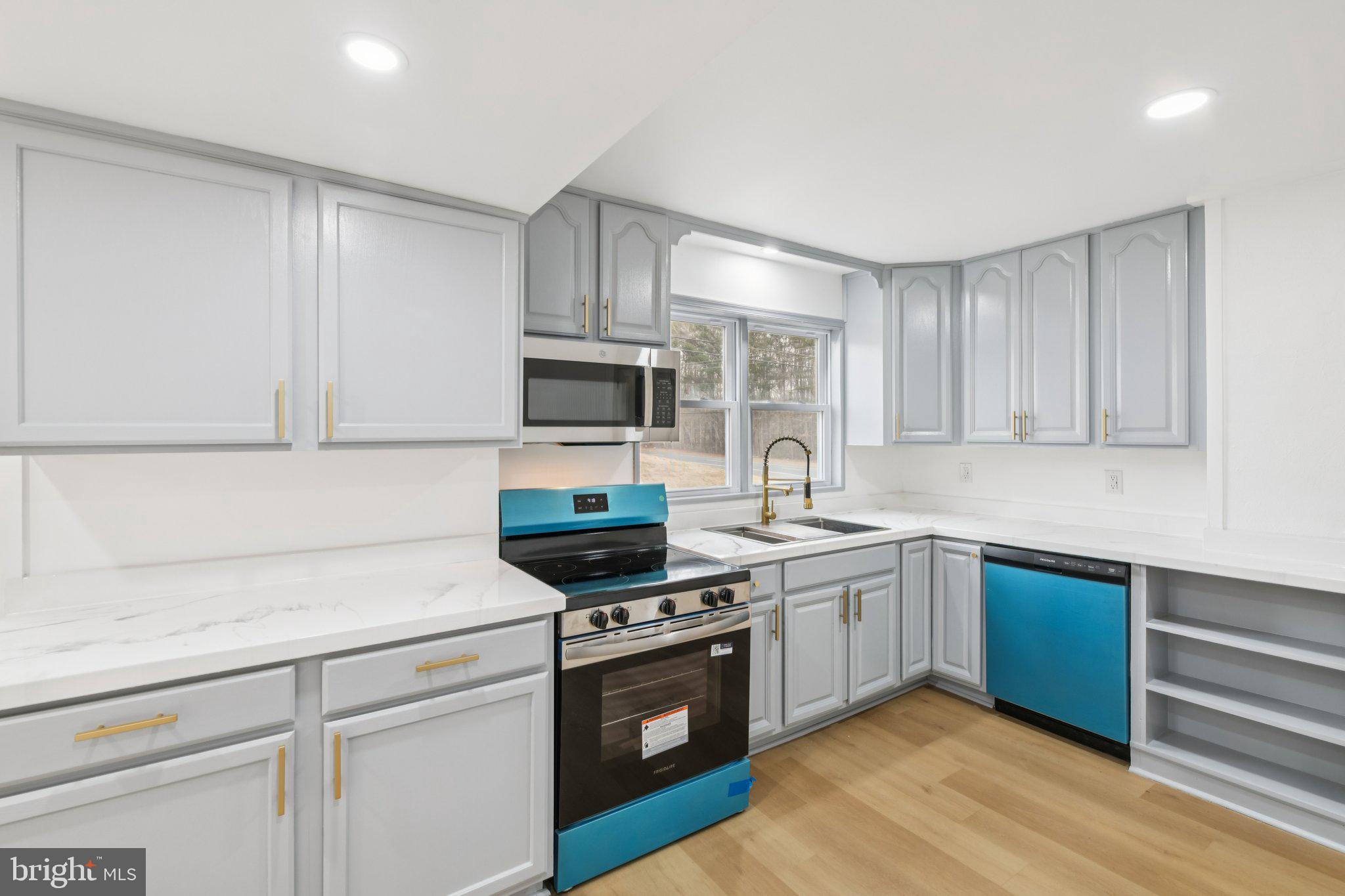 24399 Morgan Road Hollywood, MD 20636 - Photo 28 of 40 a kitchen with sink a microwave and cabinets