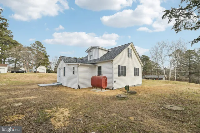 a view of a house with yard and sitting area
