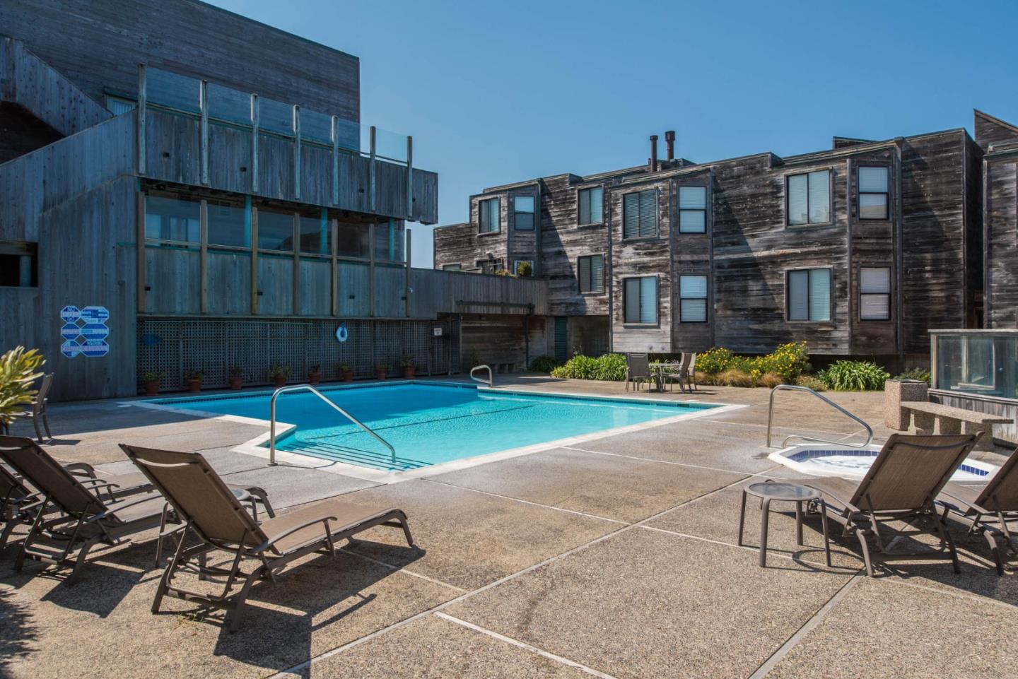 1 Surf Way, Unit 225 Monterey, CA 93940 - Photo 15 of 32 a view of a patio with a table and chairs in patio
