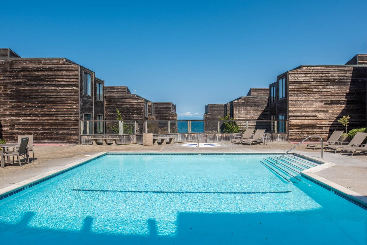 1 Surf Way, Unit 225 Monterey, CA 93940 - Photo 16 of 32 a view of swimming pool with outdoor seating and city view