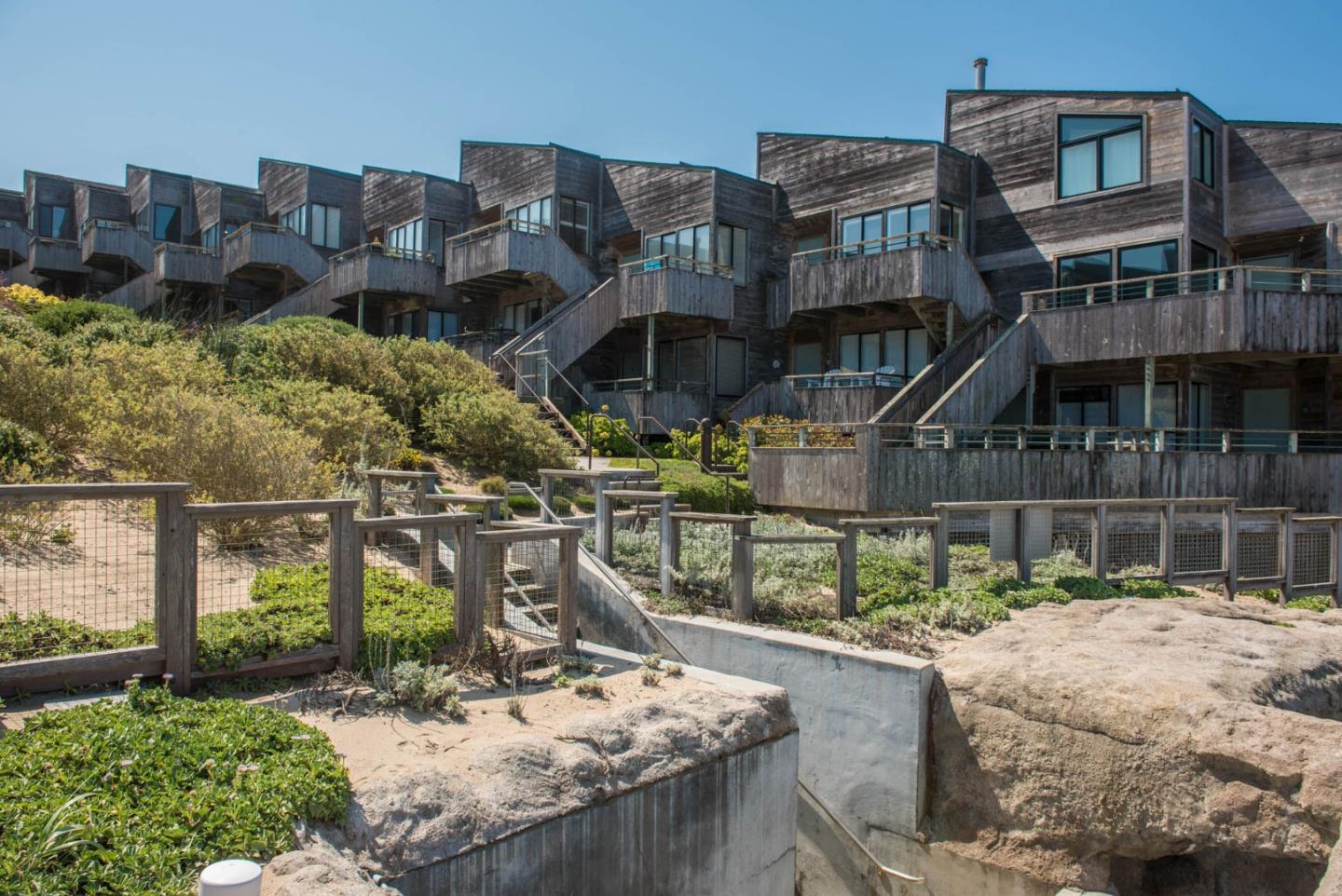 1 Surf Way, Unit 225 Monterey, CA 93940 - Photo 17 of 32 a building with trees in front of it