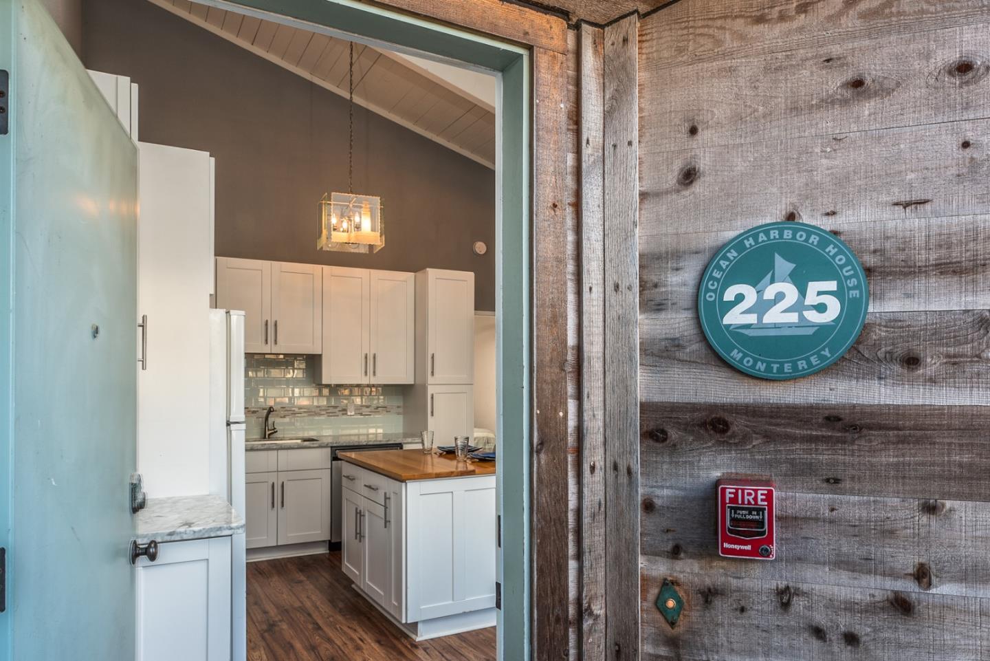 1 Surf Way, Unit 225 Monterey, CA 93940 - Photo 2 of 32 a kitchen with a refrigerator and a stove