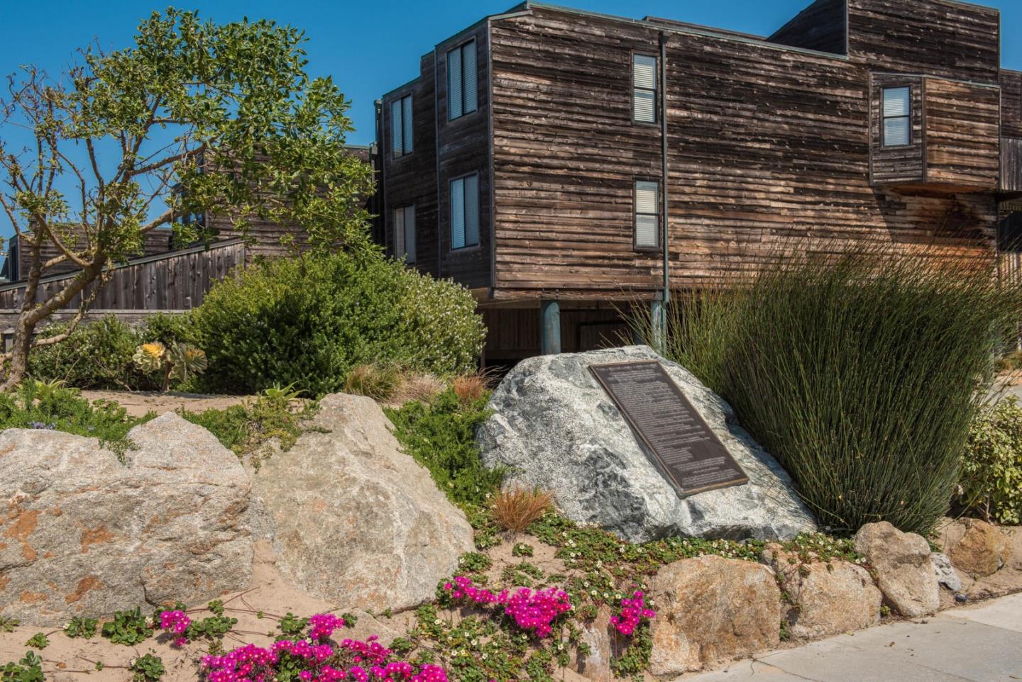 1 Surf Way, Unit 225 Monterey, CA 93940 - Photo 27 of 32 a backyard of a house with lots of green space