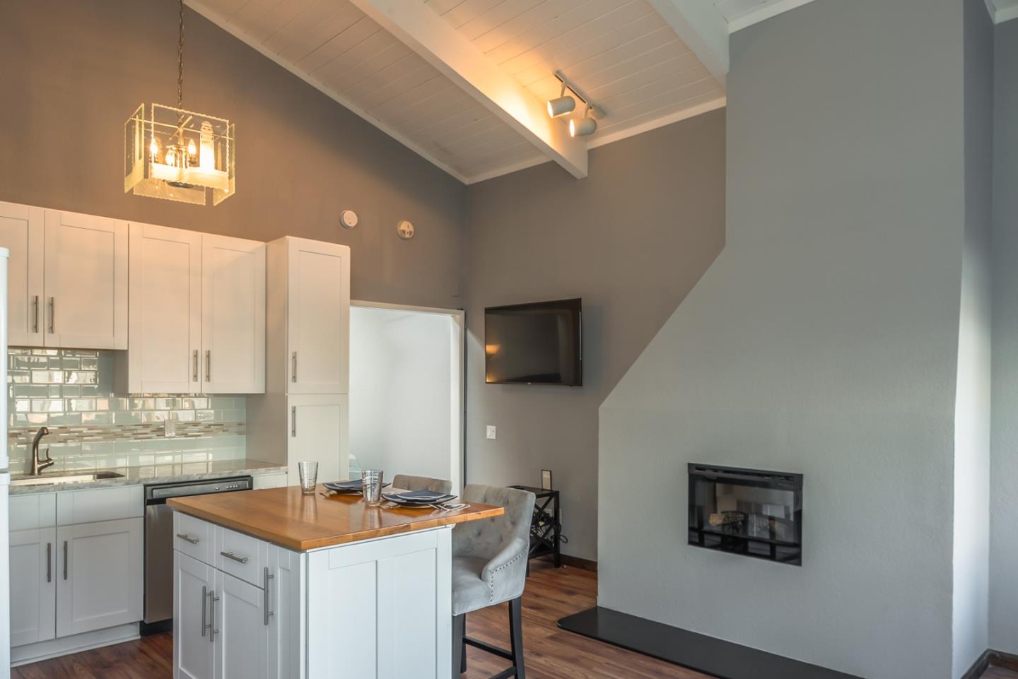 1 Surf Way, Unit 225 Monterey, CA 93940 - Photo 3 of 32 a kitchen with a sink cabinets and a window