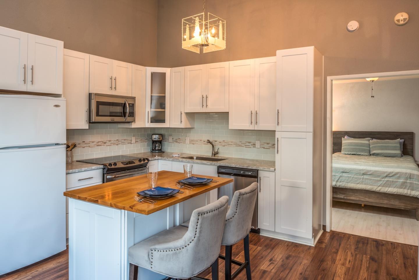 1 Surf Way, Unit 225 Monterey, CA 93940 - Photo 9 of 32 a kitchen with a sink stove top oven and microwave