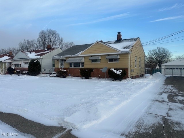 9717 Alexander Road Cleveland, OH 44125 - Photo 13 of 13 View of front facade featuring a chimney and an outdoor structure