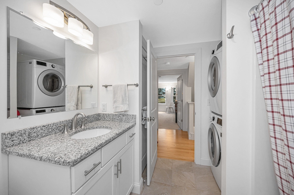 154 Chestnut Street, Unit 9 Lowell, MA 01852 - Photo 14 of 39 a bathroom with a granite countertop sink and a mirror
