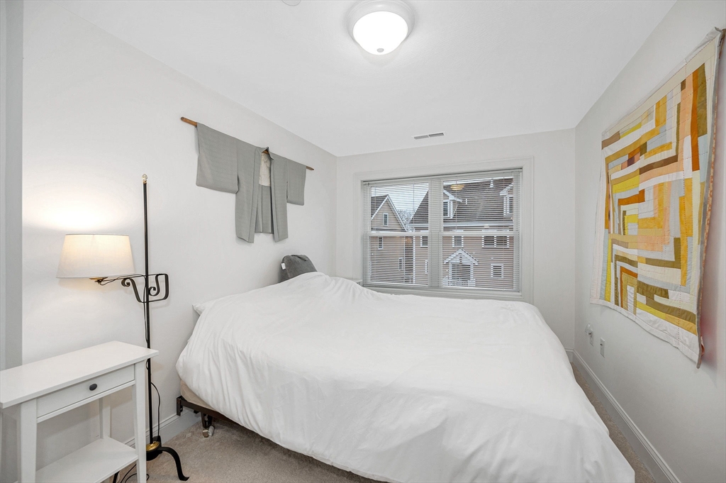 154 Chestnut Street, Unit 9 Lowell, MA 01852 - Photo 15 of 39 a bedroom with a large bed and a window