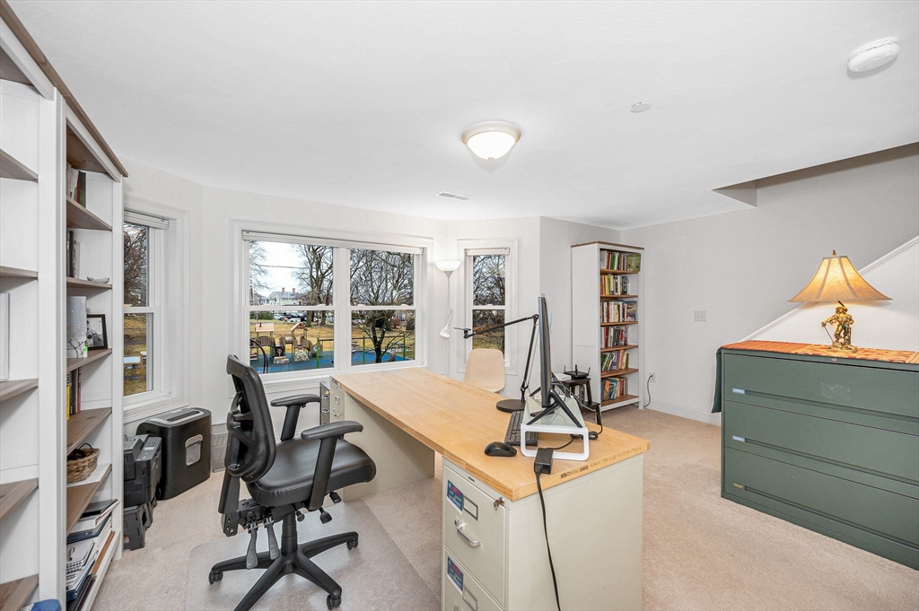 154 Chestnut Street, Unit 9 Lowell, MA 01852 - Photo 19 of 39 a view of a workspace with furniture and a window