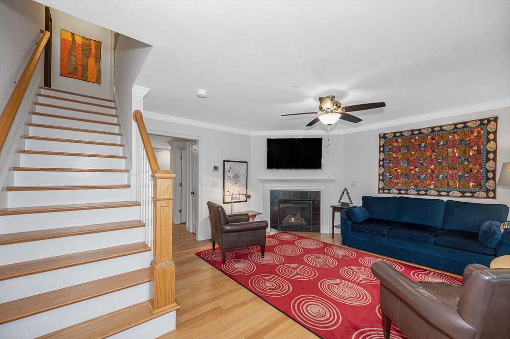 154 Chestnut Street, Unit 9 Lowell, MA 01852 - Photo 2 of 39 a living room with furniture and a fireplace