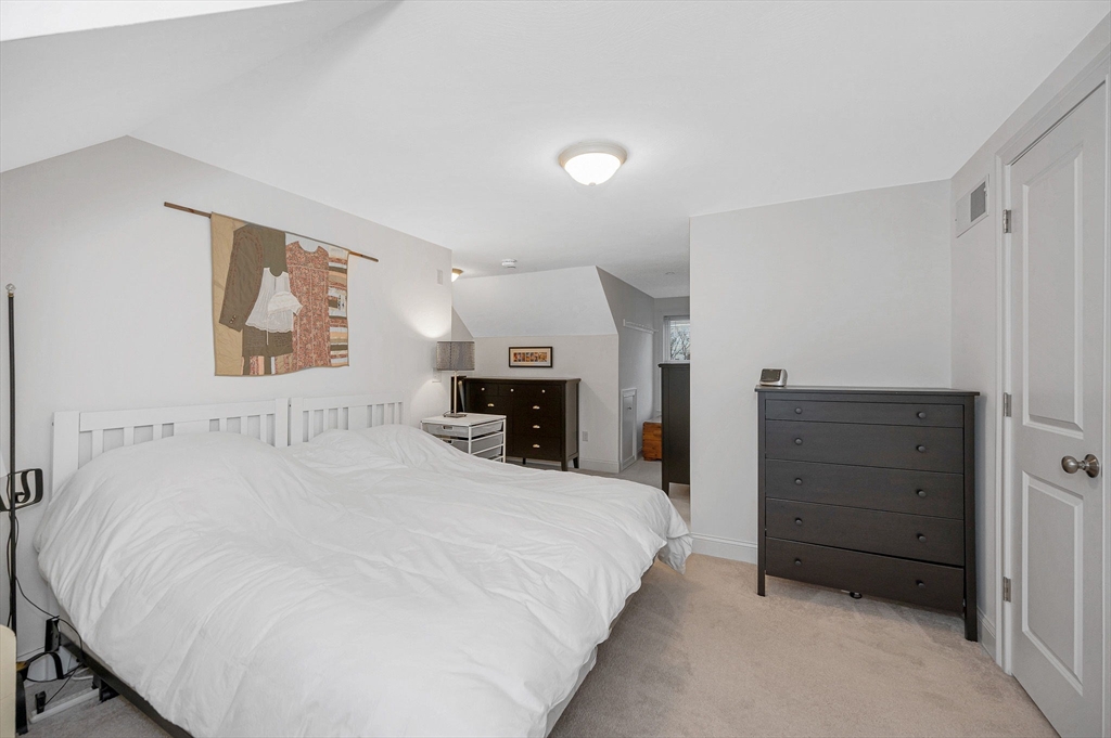 154 Chestnut Street, Unit 9 Lowell, MA 01852 - Photo 22 of 39 a large white bed in a white room