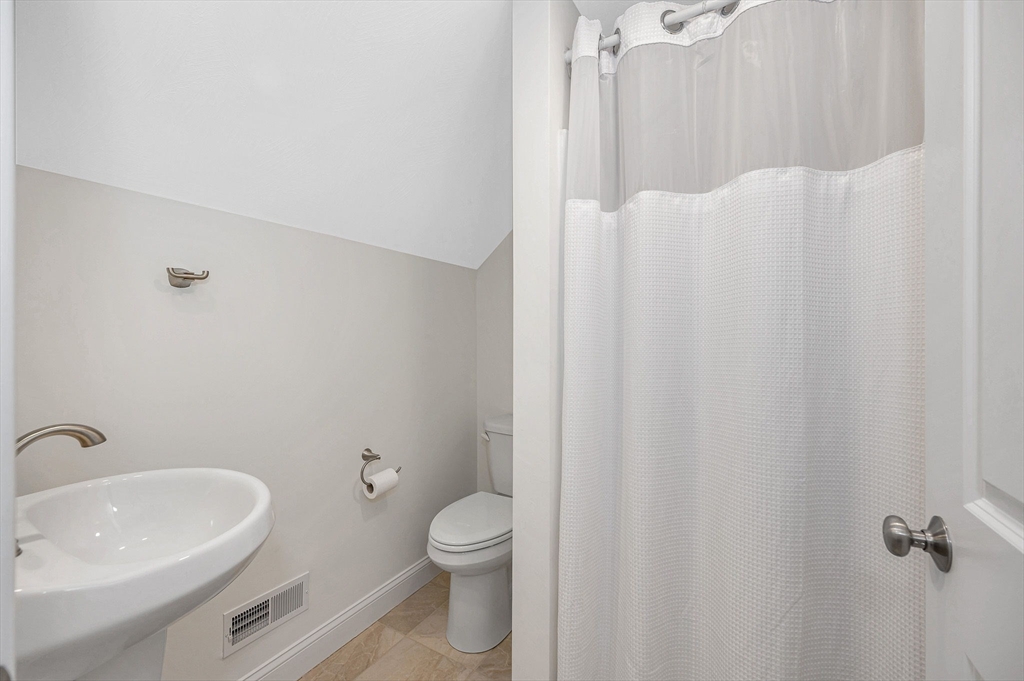 154 Chestnut Street, Unit 9 Lowell, MA 01852 - Photo 24 of 39 a bathroom with a sink a toilet and shower