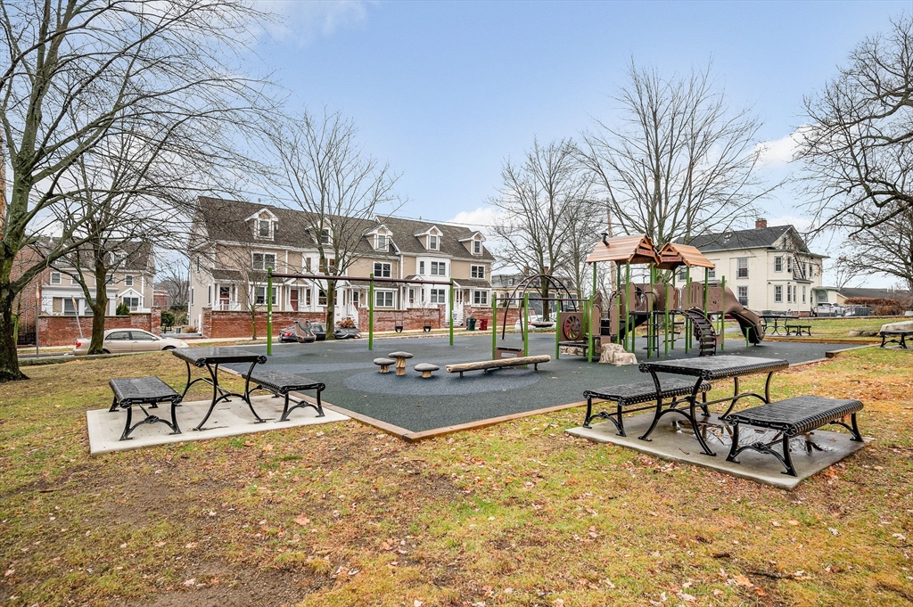 154 Chestnut Street, Unit 9 Lowell, MA 01852 - Photo 32 of 39 a view of a swimming pool with lounge chairs
