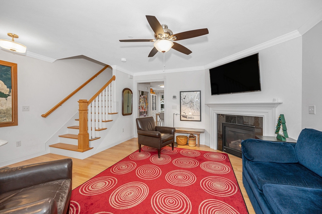 154 Chestnut Street, Unit 9 Lowell, MA 01852 - Photo 4 of 39 a living room with furniture and a fireplace