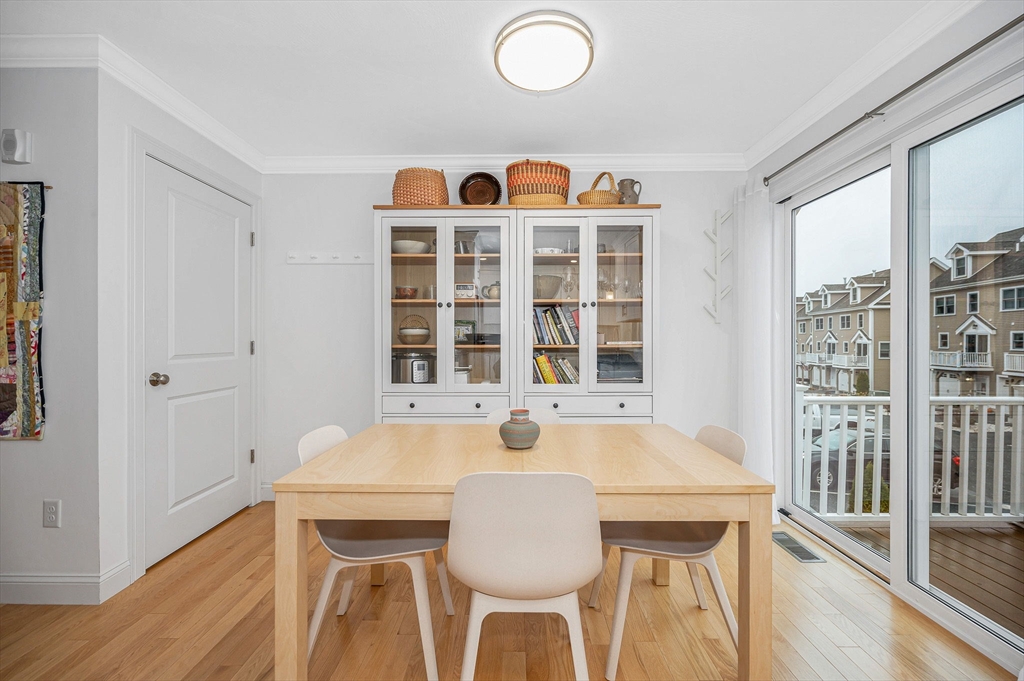 154 Chestnut Street, Unit 9 Lowell, MA 01852 - Photo 9 of 39 a view of a dining room with furniture and wooden floor