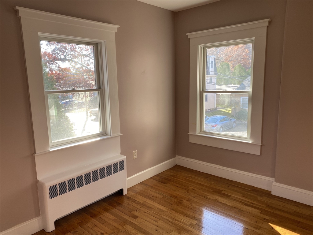 18 Highland Terrace, Unit 18 Needham, MA 02494 - Photo 11 of 14 a view of an empty room with wooden floor and a window