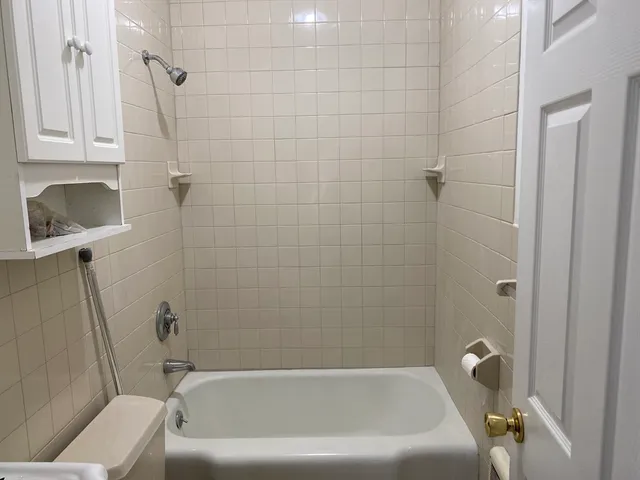a bathroom with a bathtub and a shower