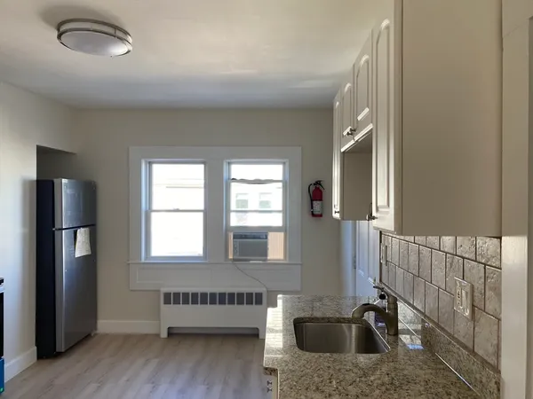 a view of a kitchen with a sink and a window