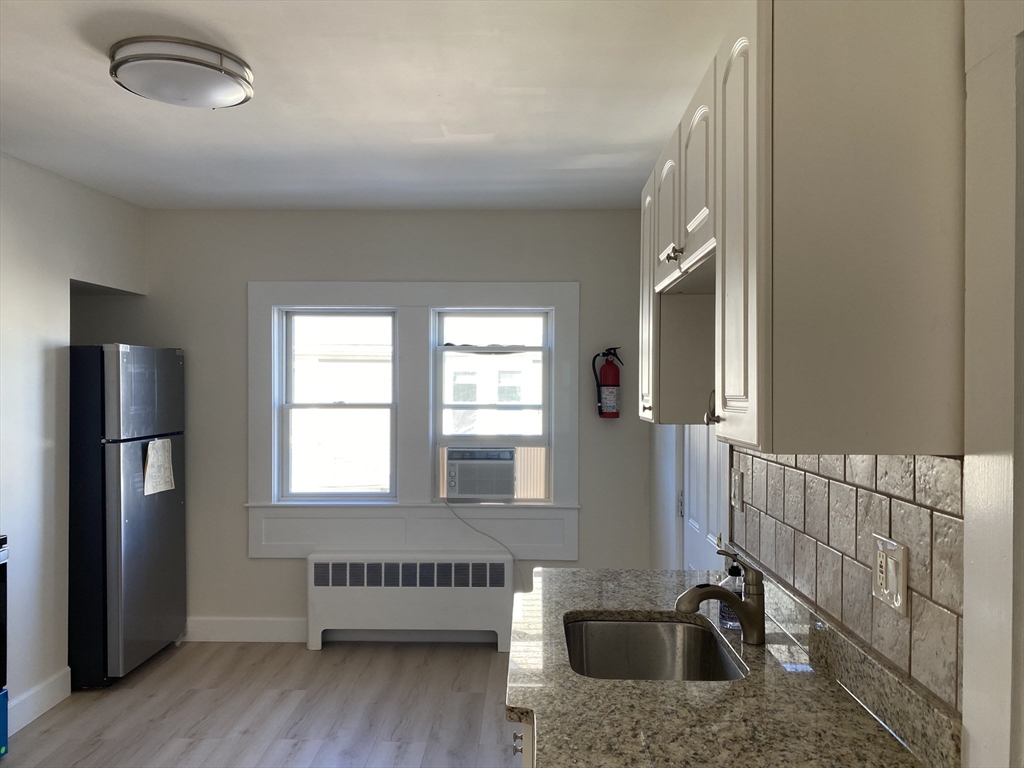 18 Highland Terrace, Unit 18 Needham, MA 02494 - Photo 3 of 14 a view of a kitchen with a sink and a window