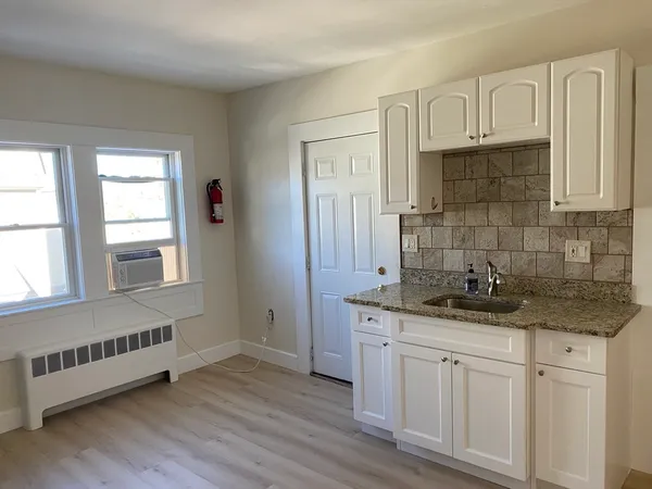 a kitchen with stainless steel appliances granite countertop a sink and a granite counter tops