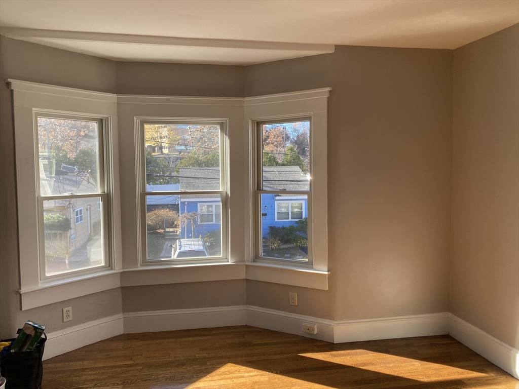 18 Highland Terrace, Unit 18 Needham, MA 02494 - Photo 7 of 14 a view of a room with wooden floor and a window